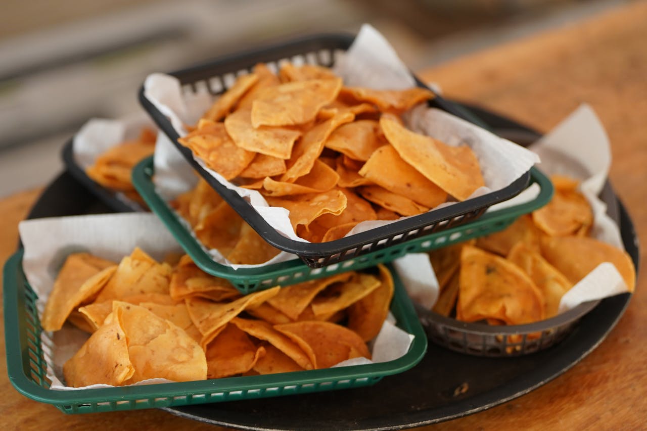 Crispy tortilla chips stacked in baskets, offering a taste of Mexican cuisine.