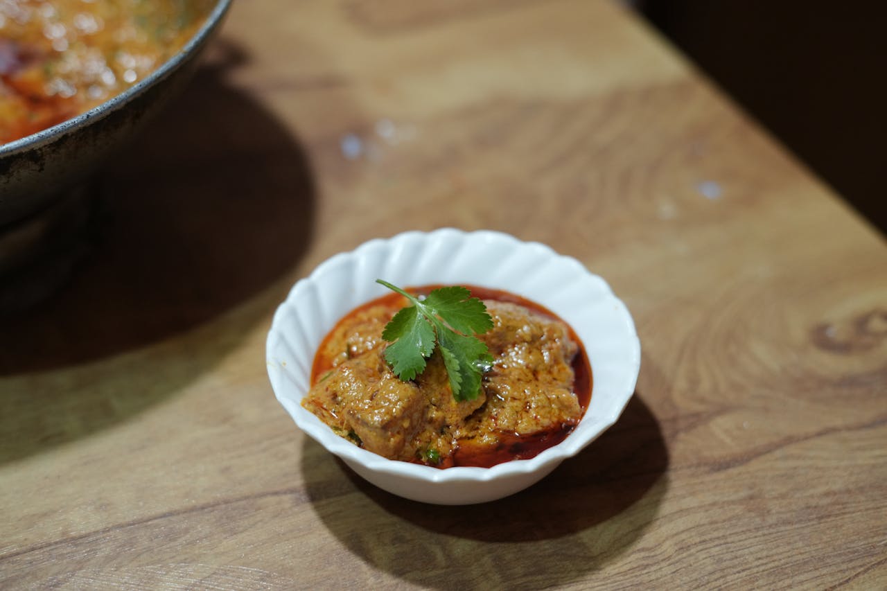A close-up of authentic paneer curry garnished with cilantro, showcasing vibrant Indian cuisine.